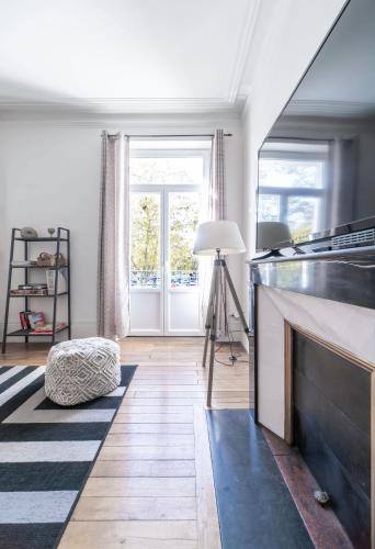 a living room with a fireplace and a window at Résidence Epinat II - Appartements centre - Parking in Vichy
