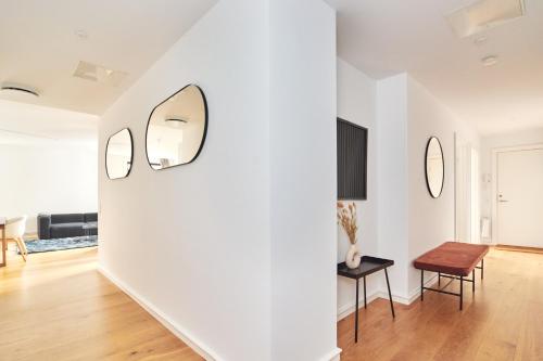 a living room with white walls and a table and chairs at Stylish 2BR w Private Balcony in CPH City Centre in Copenhagen