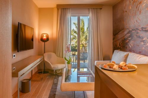 a hotel room with a table with a plate of bread at Miramare Suites in Sestri Levante