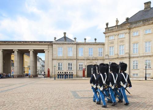 a group of people in uniform standing in front of a building at Stylish 2BR w Private Balcony in CPH City Centre in Copenhagen