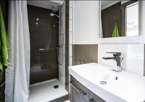 a bathroom with a sink and a shower and a tub at Coeur de Boeur in Houffalize