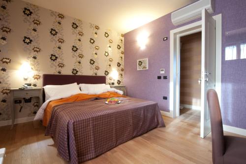 Ένα ή περισσότερα κρεβάτια σε δωμάτιο στο Hotel Locanda Stendhal