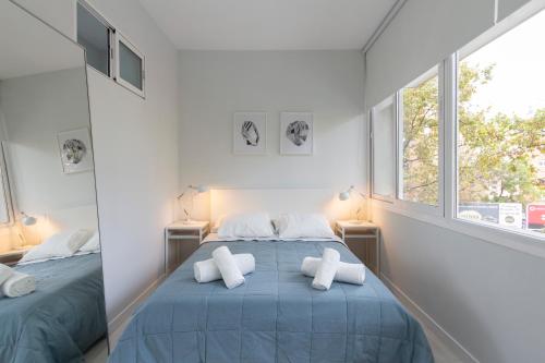 a bedroom with a blue bed with two pillows at Urbantec Realty - Plaza de Castilla in Madrid