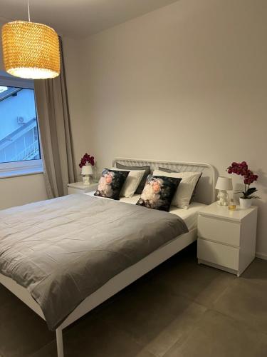 a bedroom with a bed with pillows and a window at Apartments Lily in Ljubljana