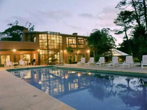 a house with a swimming pool in front of a house at Rincon del Este in Punta del Este