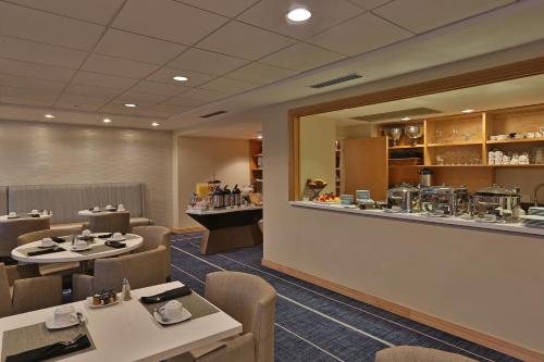 a restaurant with tables and chairs and a counter at InterContinental At Doral Miami by IHG in Miami