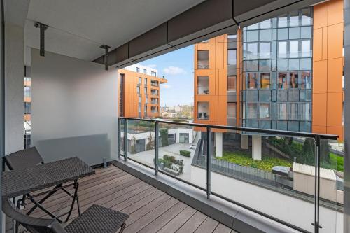 a balcony with a table and chairs on a building at Modern Old Town - Apartament w centrum Gdańska by Grand Apartments in Gdańsk