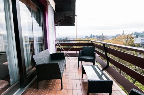 a balcony with chairs and a table and a view at Apartment Bišćan Samobor in Samobor