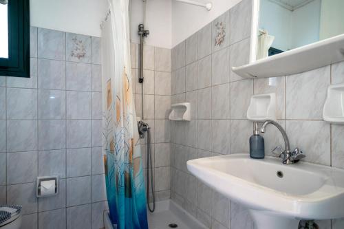 a bathroom with a shower and a sink at Pantelios Village apartment 1 in Kefallonia