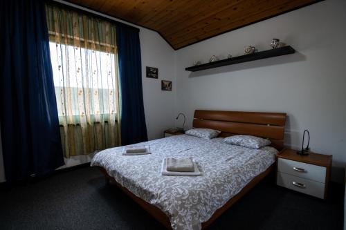 a bedroom with a bed with two towels on it at Apartment Bišćan Samobor in Samobor