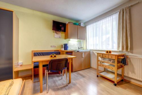 a kitchen with a desk and a table and a kitchen sidx sidx sidx at Adlerhorst in Serfaus