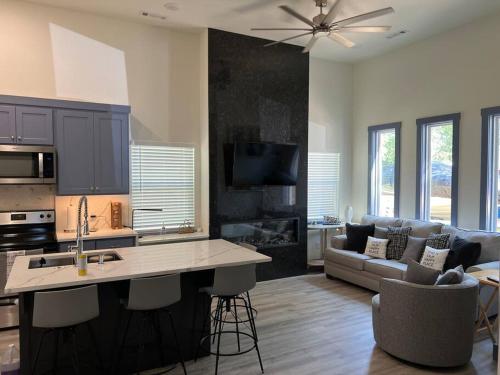a kitchen and living room with a couch and a table at Perfectly located 2 bed/2 full bathroom/1 sofa bed in Bentonville