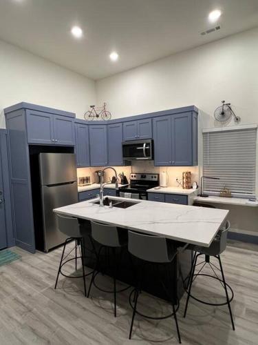 a kitchen with blue cabinets and a white counter top at Perfectly located 2 bed/2 full bathroom/1 sofa bed in Bentonville