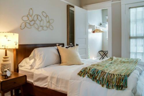 a bedroom with a white bed and a table with a lamp at Cooper Spur in Portland