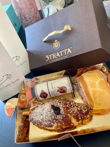 a box filled with different types of food on a table at San Carlo Suite Torino in Turin