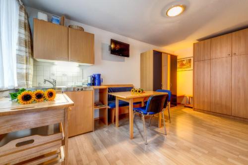 a kitchen with wooden cabinets and a table and chairs at Adlerhorst in Serfaus