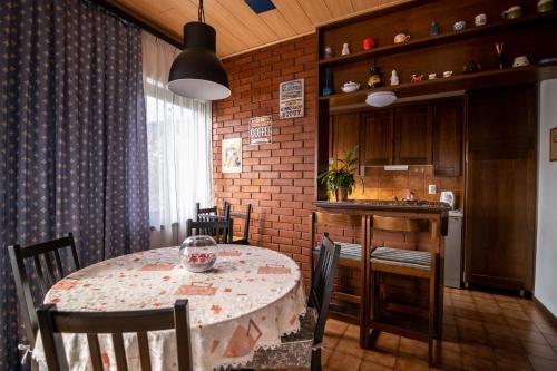 a dining room with a table and a kitchen at Apartment Bišćan Samobor in Samobor