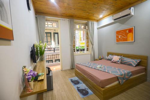 a small bedroom with a bed and a window at Radish Cathedral Homestay in Hanoi