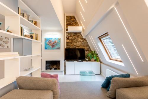 a living room with a stone wall and a fireplace at Castello Ripa Baveno in Baveno