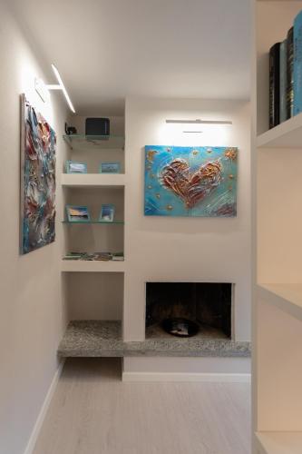 a living room with a fireplace and a painting at Castello Ripa Baveno in Baveno