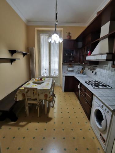 a kitchen with a table in the middle of it at LA QUALITA' AL QUADRATO in Turin