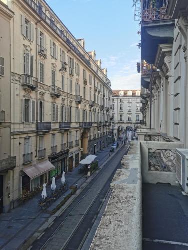 an empty street in a city with buildings at LA QUALITA' AL QUADRATO in Turin