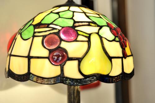 a stained glass lamp with fruit on it at Hotel al Corso in Legnano