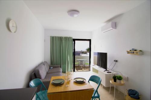 a living room with a table and a couch at Apartamento Martina in Puerto del Carmen