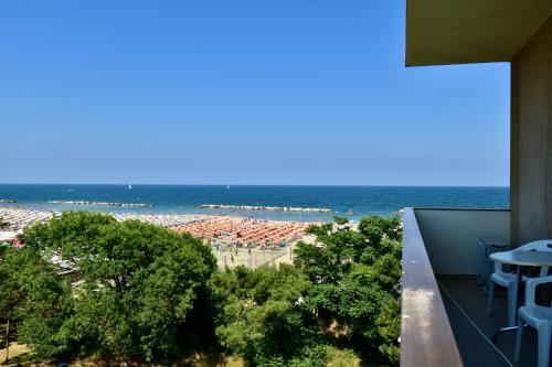 a view of the beach from the balcony of a building at Hotel Astor in Lido di Classe