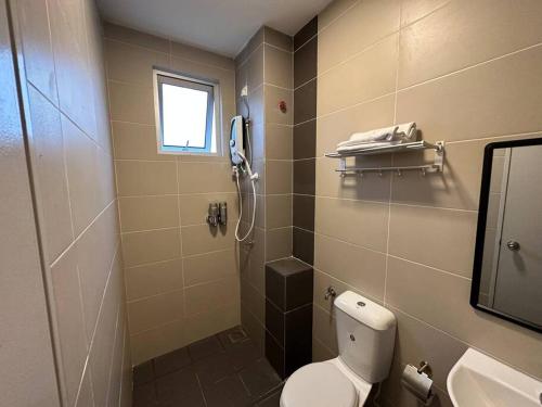 a bathroom with a toilet and a shower and a sink at AX Residence in Johor Bahru