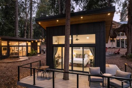 a glass house with a bedroom in it at Goat Shed in West Linn