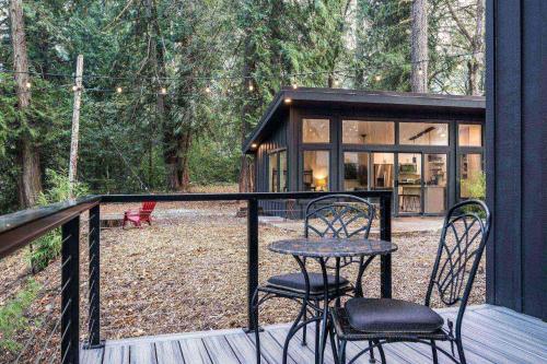 a screened in porch with two chairs and a table at Goat Shed in West Linn