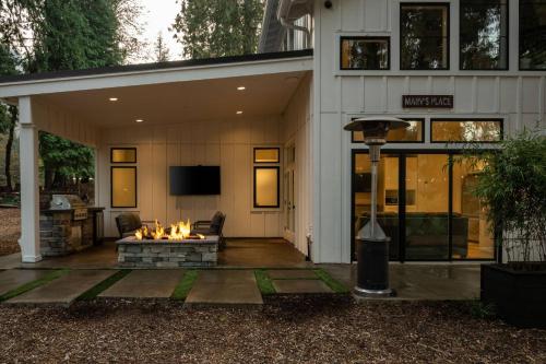 a patio with a fire pit in front of a house at Marv's Place in West Linn