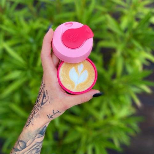 a hand holding a cup with a flower on it at Sousedi Pavlov in Pavlov