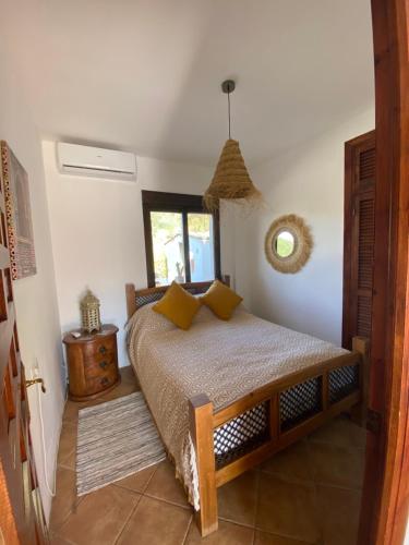 a bedroom with a bed and a window at Villa Azafran in Málaga