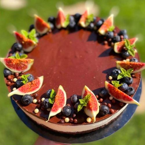 a plate with fruit on top of a cake at Sousedi Pavlov in Pavlov
