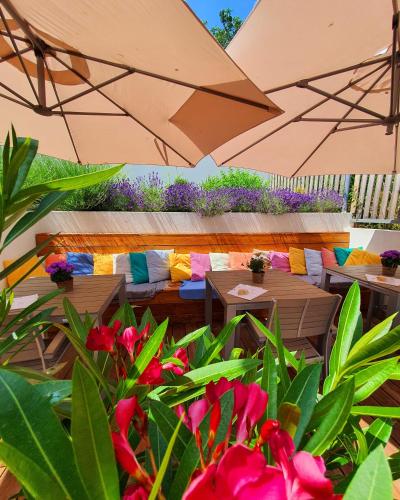 a patio with tables and chairs and an umbrella at Sousedi Pavlov in Pavlov