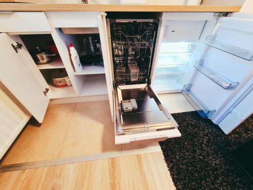 an empty refrigerator with its door open in a kitchen at The spots - 300m from the Gondola in Brzeće