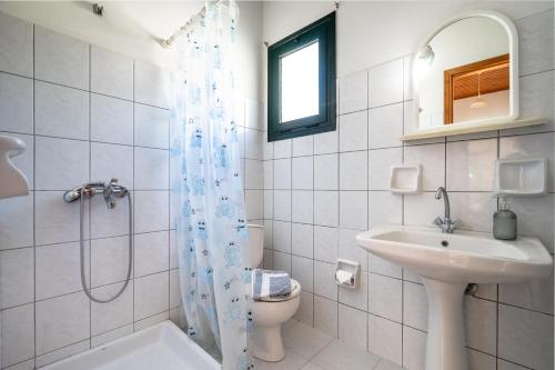 a bathroom with a sink and a toilet and a shower at Pantelios Village apartment 3 in Kefallonia