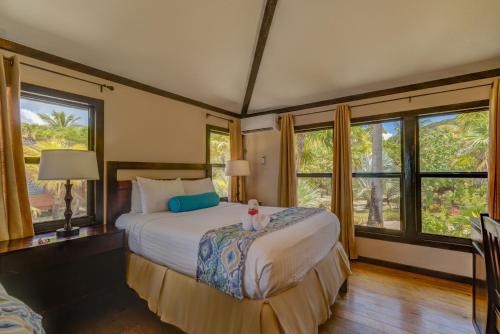 a bedroom with a bed and two windows at Anthony's Key Resort in Sandy Bay