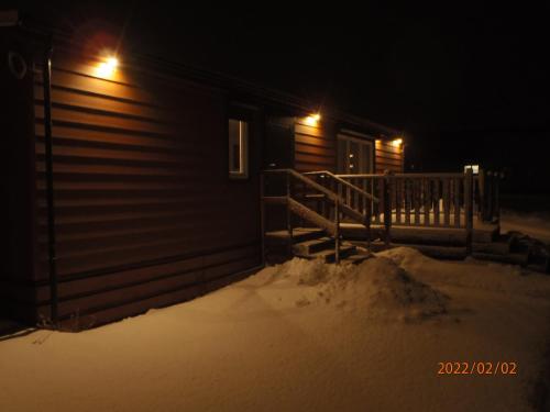 a house in the snow at night with lights at Amis apartmán 1 in Liptovský Mikuláš