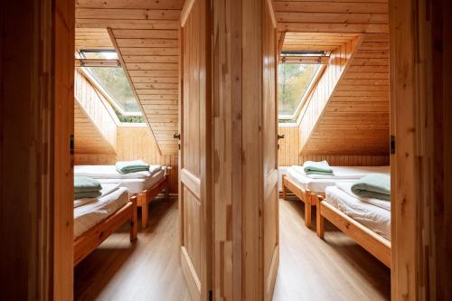 a room with four beds in a wooden cabin at House of Sparkles in Elektrėnai