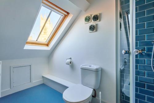 a bathroom with a toilet and a window at 37a Stonegate Loft in York