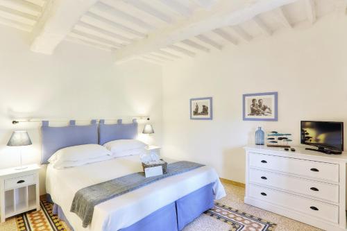 a white bedroom with a bed and a tv at Villa Cielo Blu - Homelike Villas in Montecatini Terme