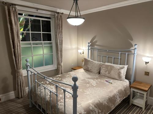a bedroom with a blue bed and a window at The Beetroot in Margate