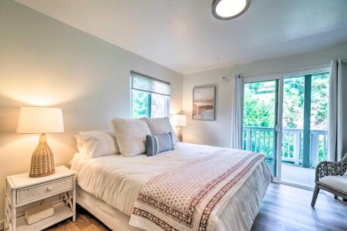 a bedroom with a bed with a lamp and a window at Cozy Cali Condo, Walk to Summerland Beach! in Summerland