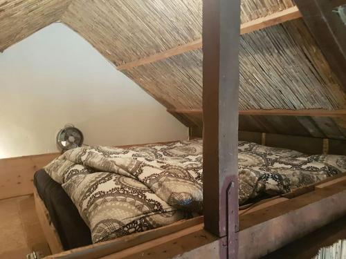 a bedroom with a bunk bed with a roof at Balistyle guesthouse in the forest near Amsterdam in Velsen-Zuid