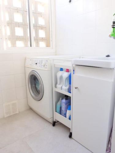 a laundry room with a washing machine and a window at Luxury apartments Alamos beach Torremolinos - Costa Lago in Torremolinos