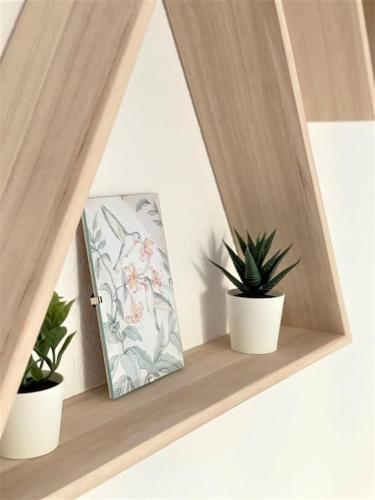 a shelf with two potted plants and a mirror at Luxury apartments Alamos beach Torremolinos - Costa Lago in Torremolinos