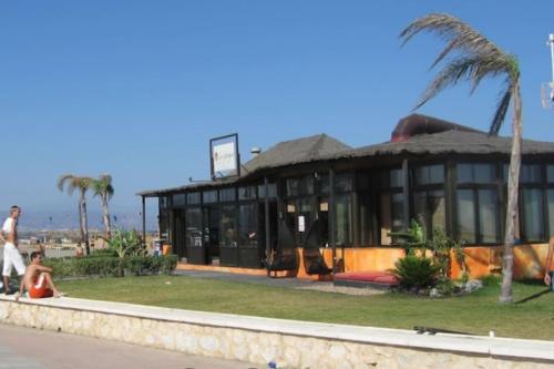 a building with a palm tree in front of it at Luxury apartments Alamos beach Torremolinos - Costa Lago in Torremolinos
